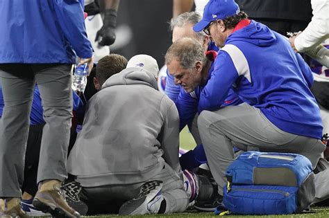 CINCINNATI, OHIO - JANUARY 02: Buffalo Bills players huddle and pray after teammate Damar Hamlin #3 collapsed on the field after making a tackle against the Cincinnati Bengals …